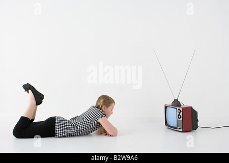 Girl watching television Stock Photo