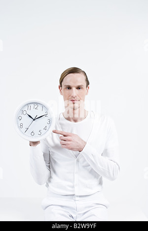 A man holding a clock
