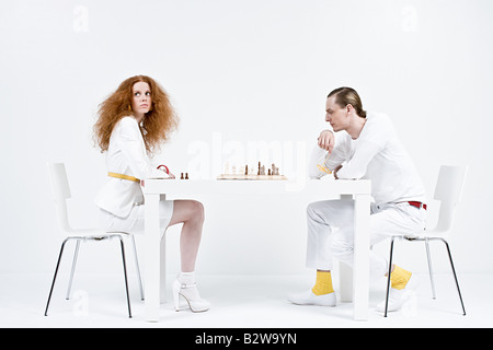 A man and woman playing chess Stock Photo