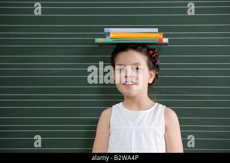 Girl with books on her head Stock Photo