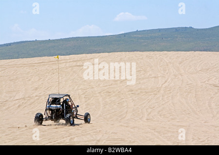 Dune buggy driving on sand dunes at St Anthony Idaho Stock Photo