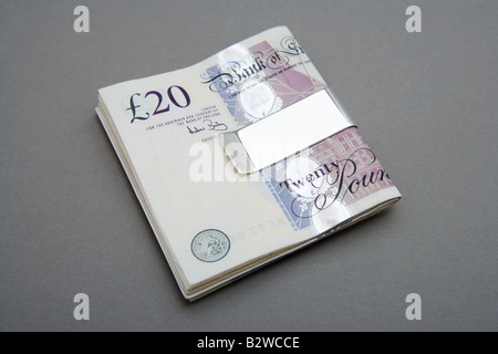 Twenty pound notes in money clip Stock Photo