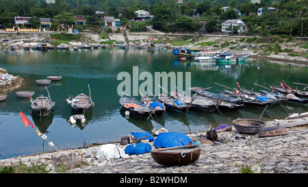 Woven coracles and traditional wooden boats harbor Cham Island off historic Hoi An Vietnam Stock Photo