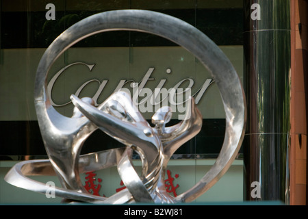 Cartier boutique jewelery store sign through modern sculpture Orchard Road Singapore Stock Photo