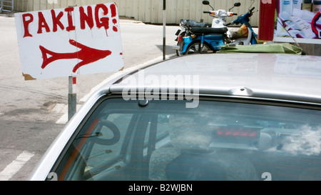 Amusing parking sign spelling mistake Malacca Malaysia Stock Photo