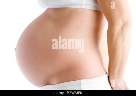 Pregnant woman's exposed belly Stock Photo