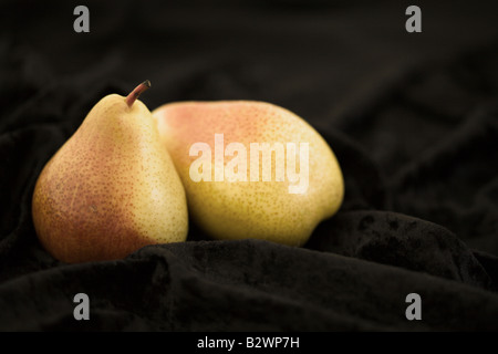 two pears of "Forelle" sort placed on black velveteen fabric Stock Photo