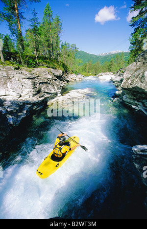 Kayaker rowing in rapids Stock Photo