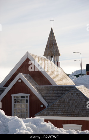 The traditional little red-painted wooden church in the village of Ittoqqortoormiit, Scoresbysund, East Greenland Stock Photo