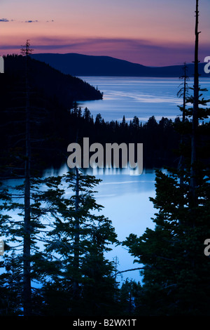 The soft hues of dusk appear in the sky above the northern shore of Lake Tahoe California Stock Photo