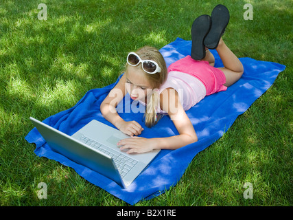 Child working on her laptop Stock Photo