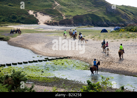 Pony Trekking across Pennard Burrows in Threecliffs Bay Gower Stock Photo