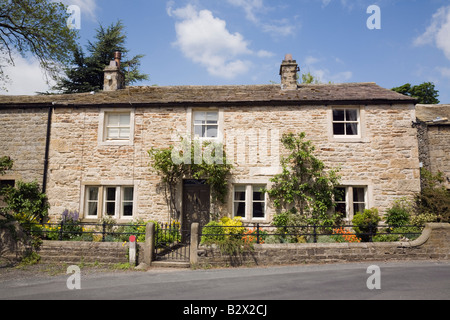 Traditional old stone cottage house front in village in Yorkshire Dales National Park. Burnsall Wharfedale North Yorkshire England UK Stock Photo