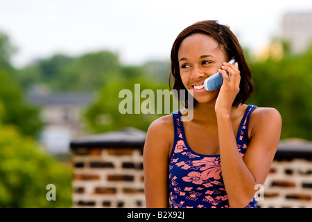 A young African-American female talks on her cell phone. Stock Photo