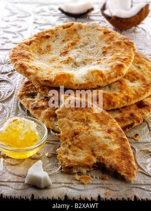 Peshwari Naan. coconut sultanas and honey Bread served ready to eat on a table - Indian Cuisine Stock Photo