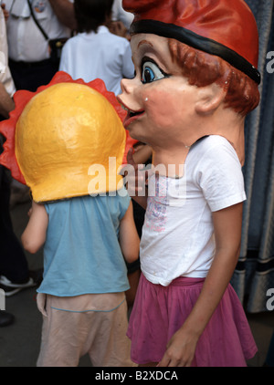 Children playing with masks at a traditional 'gathering of giants' in Barcelona, Catlonia, Spain Stock Photo