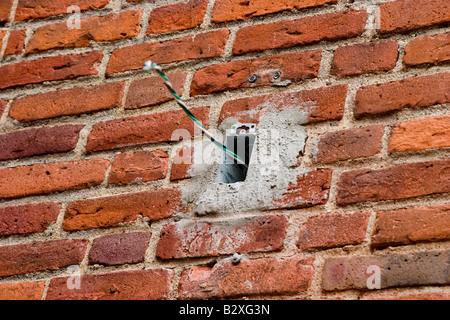 Unattached wires sticking out of an electrical box Stock Photo