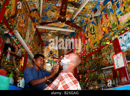 a tourist is getting a shave in Pokhara,Nepal Stock Photo