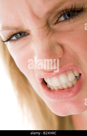Head shot of woman scowling Stock Photo