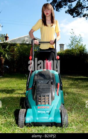 Teenage Girl Mowing the Lawn Model Released Stock Photo