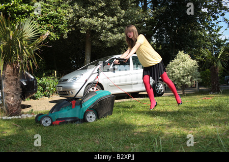 Teenage Girl Mowing the Lawn Model Released Stock Photo