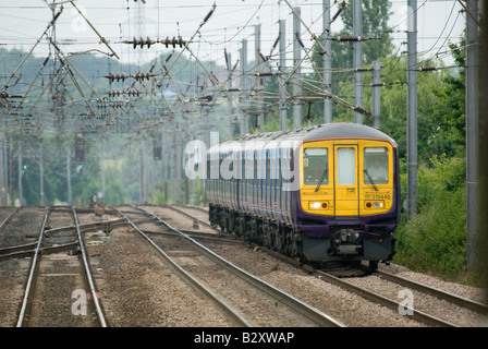 class 319 train in first capital connect livery travelling beneath catenary in the uk Stock Photo