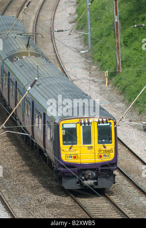 class 319 train in first capital connect livery travelling beneath catenary in the uk Stock Photo