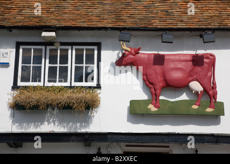 Red cow sign on public house Stock Photo