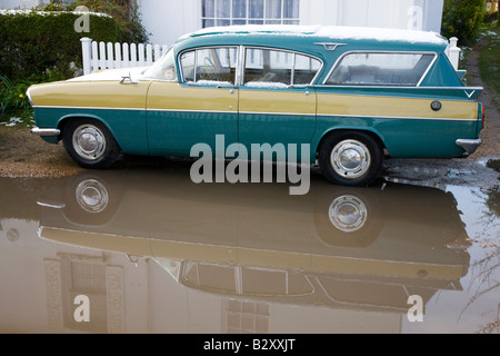 Classic 1950s Vauxhall Cresta estate conversion parked in a puddle outside cottage Stock Photo