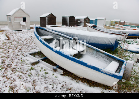 Beach huts in the snow on the beach in Kingsdown near Deal Kent Stock Photo
