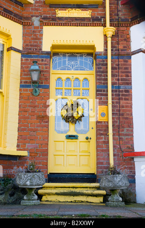 Attractive front door with bright yellow colour scheme Stock Photo