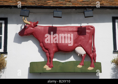 Red cow sign on public house Stock Photo