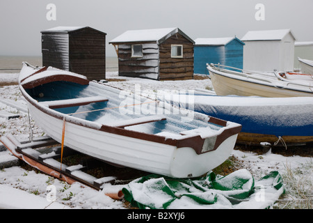 Beach huts in the snow on the beach in Kingsdown near Deal Kent Stock Photo