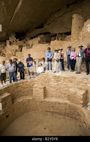 Tourists viewing kiva at Cliff Palace cliff dwelling Indian ruin, Mesa Verde National Park, Colorado Stock Photo