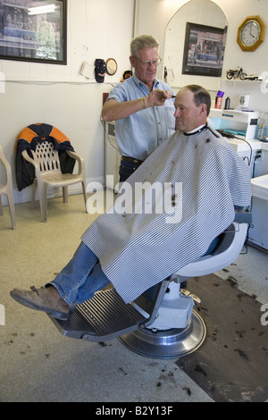 Man getting haircut in Gordon's Barbershop in Palisade Colorado, east of Grand Junction Stock Photo