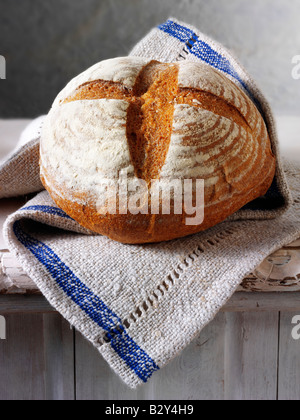 Artisan English Rye bread loaf  in a rustic setting on a table Stock Photo