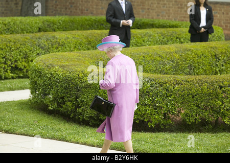 Queen Elizabeth II in bright purple outfit and black purse, walking to Governor's Palace in Williamsburg VA Stock Photo