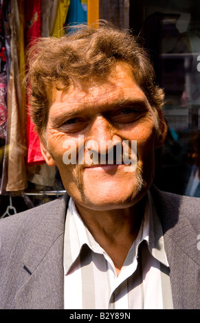 Tough looking giant man with extreme large head in city center in Lviv Ukraine Stock Photo