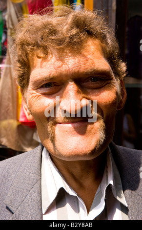 Tough looking giant man with extreme large head in city center in Lviv Ukraine Stock Photo