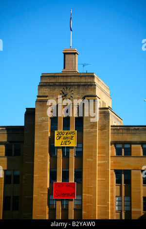 Signs that accuse Australian of racism are displayed on the Museum of Contemporary Art at Circular Quay in Sydney Australia Stock Photo