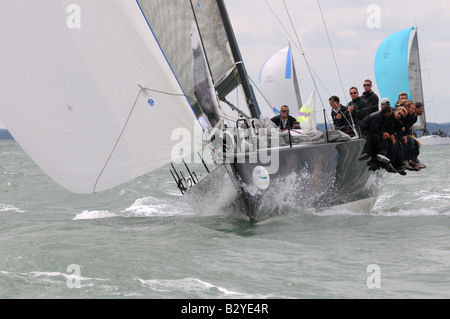 Bow of racing yacht TP52 design cutting through the waves sailing Cowes Week Isle of Wight Stock Photo