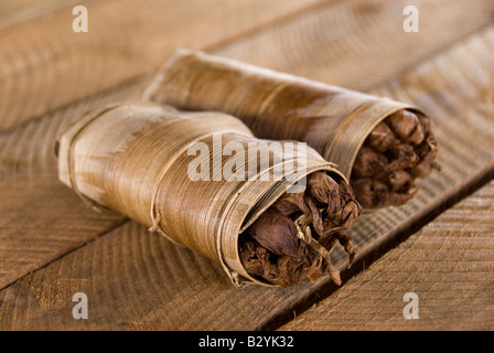 Home made and hand rolled Cuban cigars bundled together in a dried leaf Vinales Cuba Stock Photo