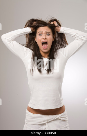 Woman Pulling Hair And Screaming At Camera Portrait Stock Photo Alamy