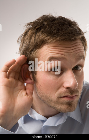 Portrait of Man Cupping Ear Stock Photo