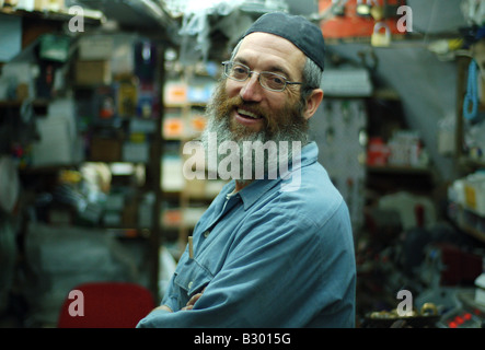 A religious Jewish iron-monger takes a break from work in his store in the Jewish Quarter of Jerusalem's Old City. Stock Photo
