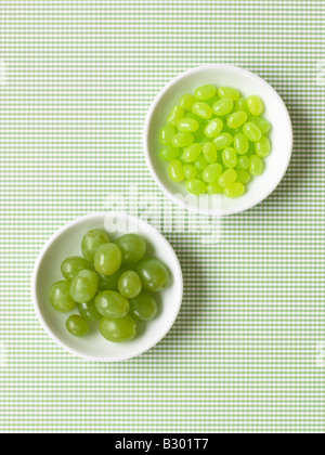 Grapes and Jelly Beans in Bowls Stock Photo