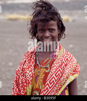 Djibouti, Lake Abbe. A pretty tousle-haired girl of the nomadic Afar tribe wears bright colours Stock Photo