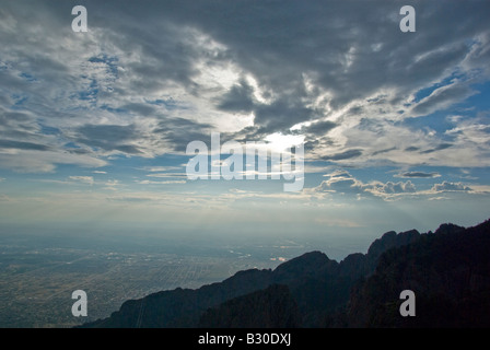 A panorama of the Sandia mountains, clouds and the Albuquerque city spreading below