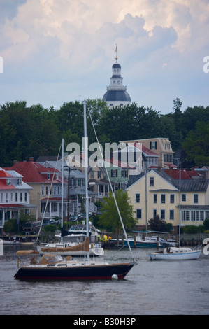 Sailboats moored along the Annapolis waterfront with the historic state capital building in the skyline Stock Photo