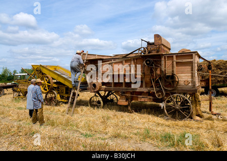 French farmers working thresher and baler machine at agricultural show, Indre, France. Stock Photo